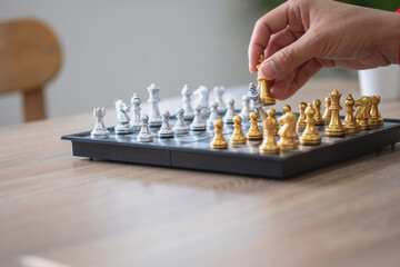 The company is businessman is hands move chess on the game plan to win the business in the market. concept of leadership