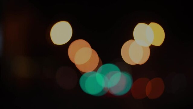 Blurred footage of transport. Blur of city lights along the road, out of focus light at night. Traffic on the road of the night city, beautiful background.