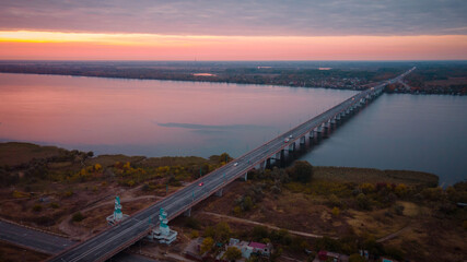 The road to Krym through the Kherson Bridge in Antonovka. A bridge across the Dnieper River connecting the right and left banks - obrazy, fototapety, plakaty