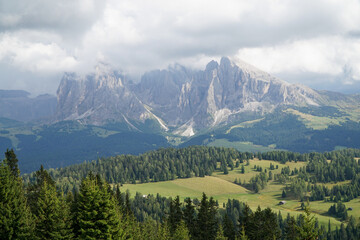Fototapeta na wymiar majestic mountain view in the dolomites: beautiful and famous alp di siusi and distinctive sassolungo mountain group at gardena valley in south tyrol. 