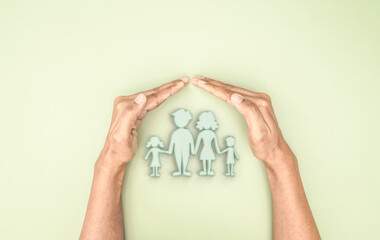 Hand holding covered 3d family symbolic icon, planning family protection by insurance or family care and support concept - 545633171