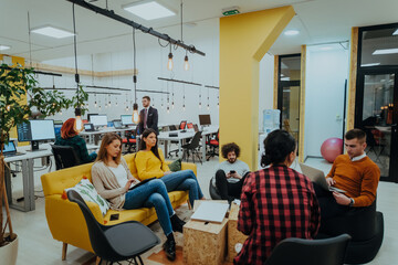 Naklejka premium Multiethnic group of employees working in a marketing company. A group of colleagues is working on a project in modern offices