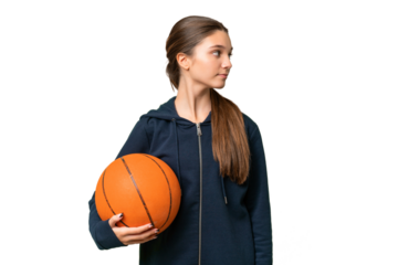 Teenager caucasian girl playing basketball over isolated background looking to the side