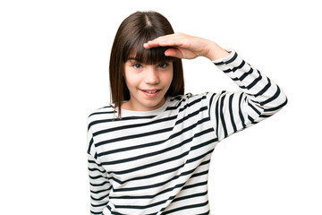 Little caucasian girl over isolated background looking far away with hand to look something