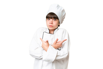Little caucasian chef girl over isolated background pointing to the laterals having doubts