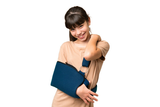 Little caucasian girl with broken arm and wearing a sling over isolated background laughing