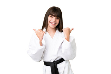Little Caucasian girl doing karate over isolated background with thumbs up gesture and smiling © luismolinero