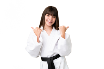Little Caucasian girl doing karate over isolated background with thumbs up gesture and smiling