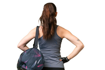 Young sport woman with sport bag over isolated background in back position