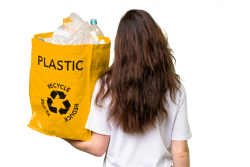Young caucasian woman holding a bag full of plastic bottles to recycle over isolated background in back position