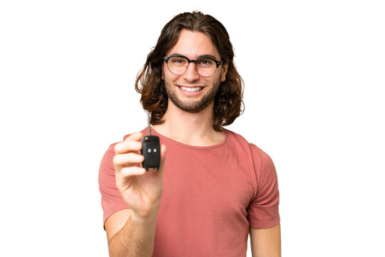 Young handsome man holding car keys over isolated background with happy expression