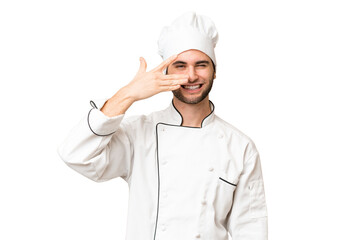 Young handsome chef man over isolated background covering eyes by hands and smiling