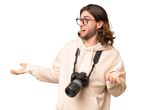 Young photographer man over isolated background with surprise facial expression