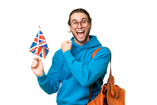 Young handsome man holding an United Kingdom flag over isolated background celebrating a victory