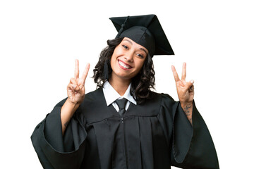 Young university graduate Argentinian woman over isolated background showing victory sign with both...
