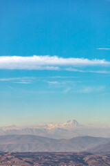 peak of Mount Kazbek among other mountains