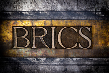 BRICS text with on grunge textured copper and gold background