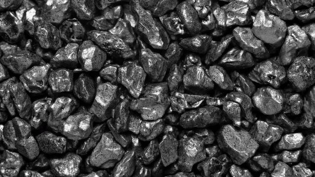 Black stones moving. Close-up of a black stones surface moving.