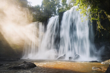 High waterfall in mountains at morning light. Tropical landscape in Camobodia..