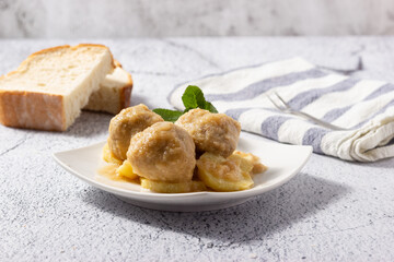 Delicious homemade meatballs with potatoes and traditional sauce.