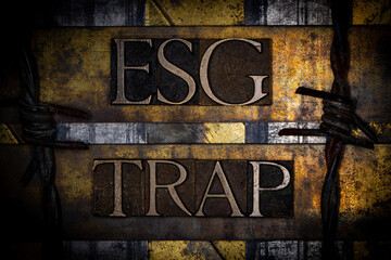 ESG Trap text with barbed wire on grunge textured copper and gold background