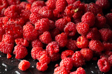 Fresh raspberries on dark background. Close up. Selective focus. useful product