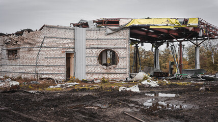 Fototapeta na wymiar War in Ukraine, fighting, explosion-damaged building, destroyed gas station, Izyum Kharkiv region