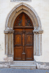 Wooden carved door. Streets of old town of Tallinn. Autumn daytime.