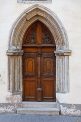 Fototapeta na wymiar Wooden carved door. Streets of old town of Tallinn. Autumn daytime.