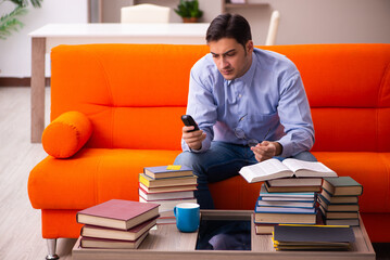 Young male student preparing for exams at home