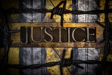 Justice text with barbed wire on grunge textured copper and gold background