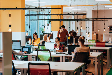 Multiethnic group of employees working in a marketing company. A group of colleagues is working on a project in modern offices