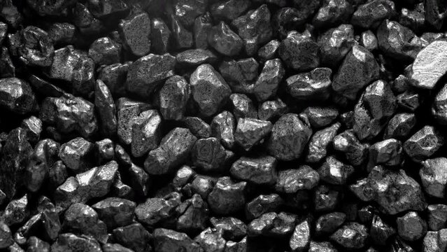 Black stones moving. Close-up of a black stones surface moving.