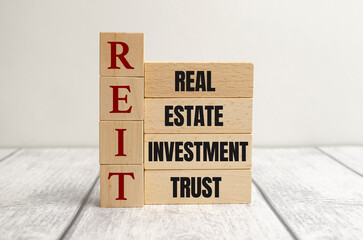 REIT Real Estate Investment Trust abbreviation on wooden blocks