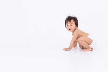 Side view of Adorable Asian baby in diaper sitting and crawling isolated white background. Happy little baby boy smile playing and enjoy. Healthy and strong baby learning to crawing and walking. - obrazy, fototapety, plakaty