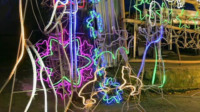 Parols for sale at a stand at nighttime. A Filipino ornamental lantern displayed during the Christmas season.