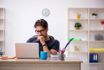 Young male designer working in the office