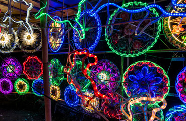 Parols for sale at a stand at nighttime. A Filipino ornamental lantern displayed during the Christmas season.