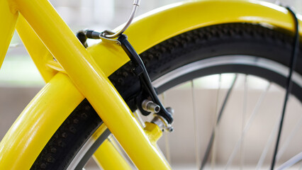 close up of yellow bicycle wheel