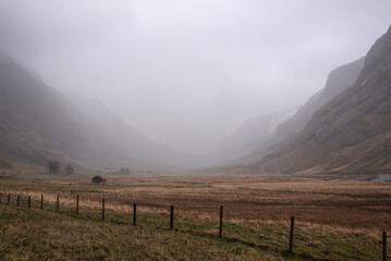 Dark and moody Winter landscape image of Lost Valley Etive Mor in Scottish Highlands wirth dramatic clouds overhead © veneratio