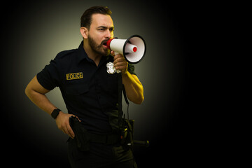 Police agent looking angry shouting using a megaphone