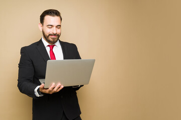 Happy lawyer or businessman using a laptop