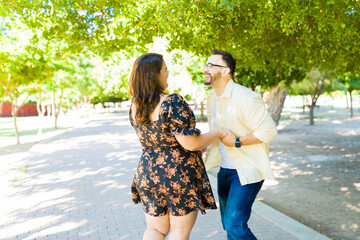 Happy couple having fun while on a date at the park