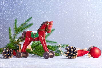 Christmas card with vintage wooden horse decoration for christmas tree and garland at old board.