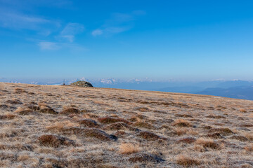 Hiking trail on frozen alpine meadow from Ladinger Spitz to Gertrusk, Saualpe, Lavanttal Alps,...