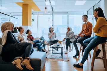 Young designer giving some new ideas about project to his partners in conference room. Business people discussing over new business project in office.