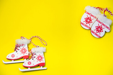 New Year's layout on a yellow background, mittens, skates, with Wooden inscription Happy New Year