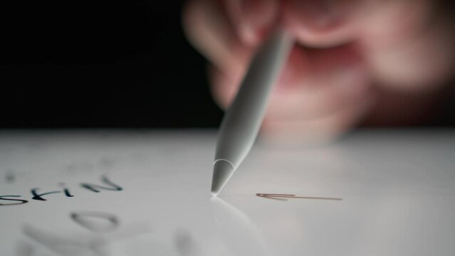 Man draws arrows to achieve goals on a tablet using a special pencil, digital drawing