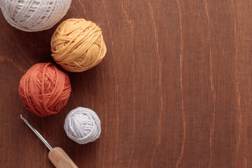 Cotton Yarn Balls for Crocheting Handmade on a Light Colored Wooden background