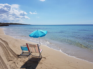 Deckchair with built-in parasol on the beach.
